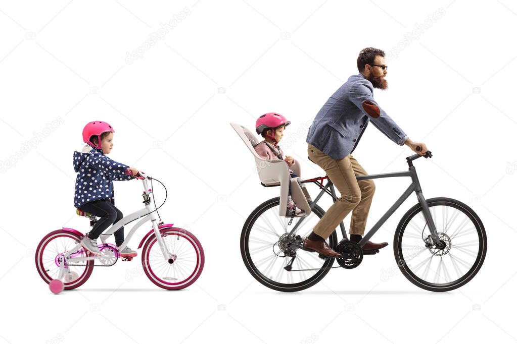 Father riding a bicycle with a child seat and a little girl ridi