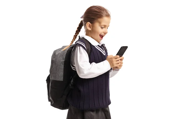 Cep telefonu tutan mutlu küçük okul kızı. — Stok fotoğraf