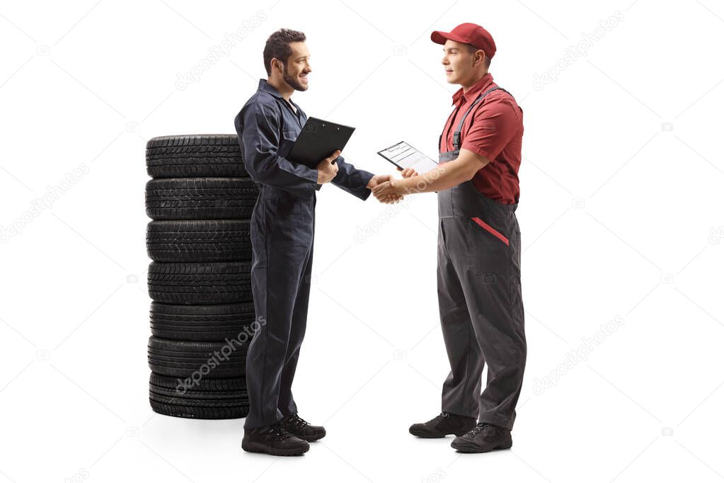 Auto mechanic shaking hands with a delivery man
