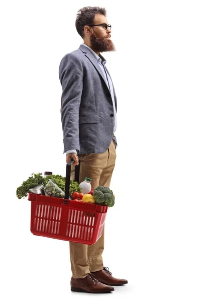 Uomo barbuto in piedi con un carrello pieno — Foto Stock