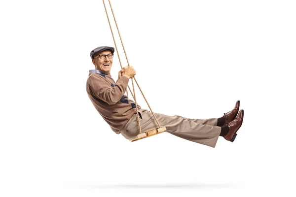 Smiling senior getleman swinging and looking at the camera — Stockfoto