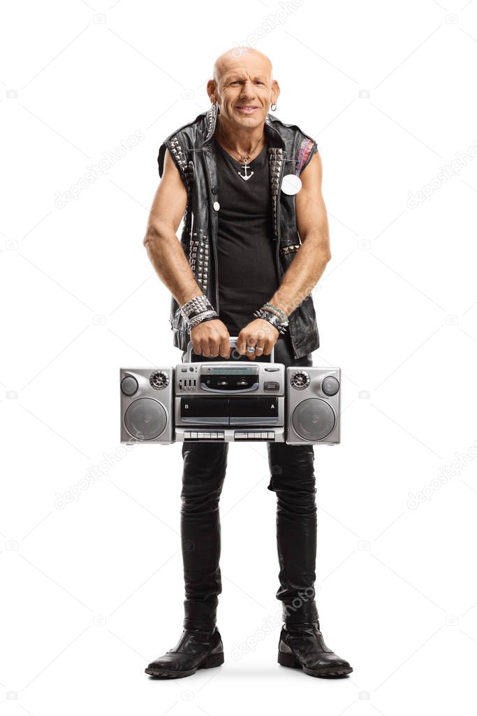 Punker in leather outfit holding a boombox radio