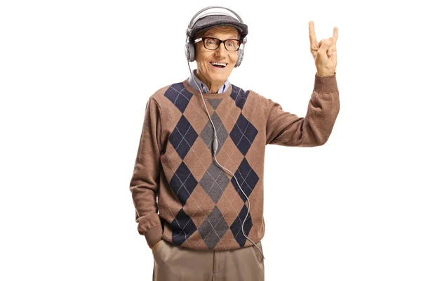 Elderly gentleman with headphones making a rock and roll sign — Stock Photo, Image