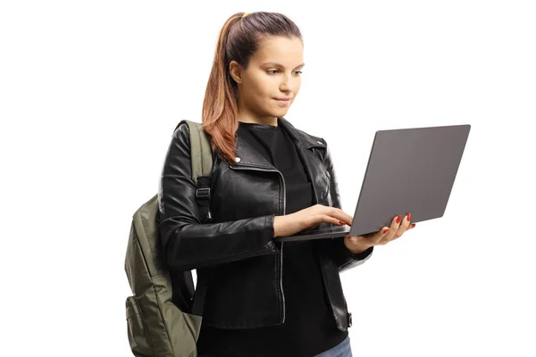 Female student standing and using a laptop computer — ストック写真