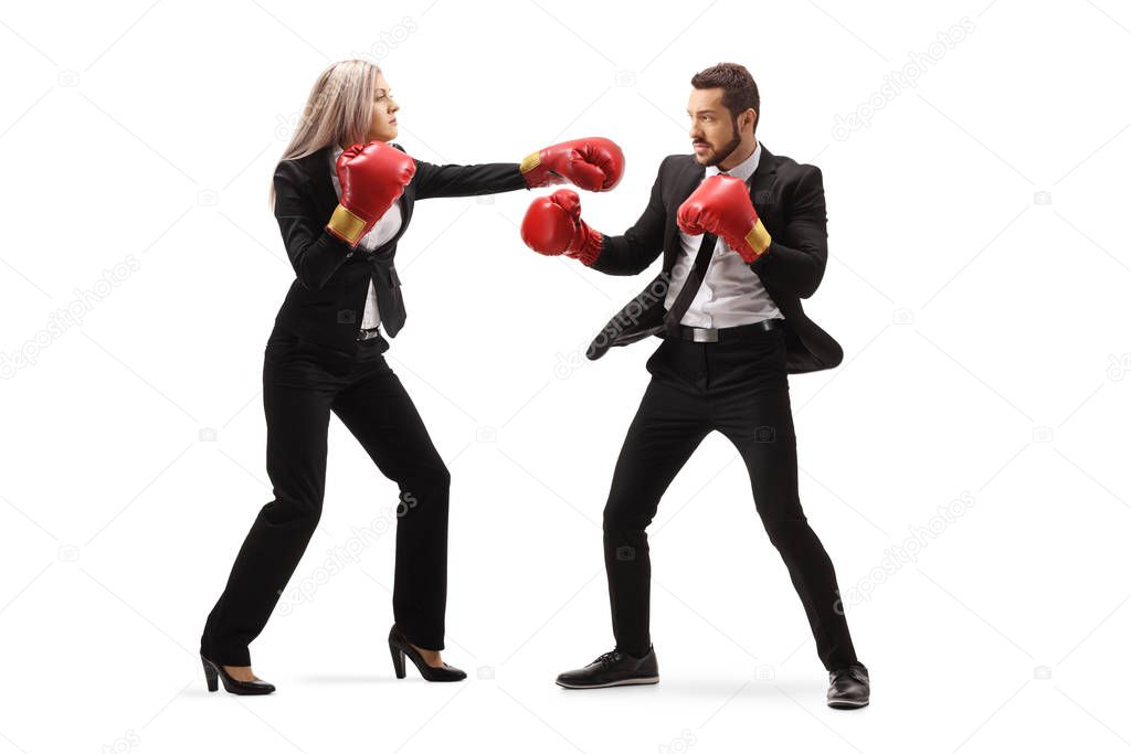 Businesswoman hitting a businessman with boxing gloves