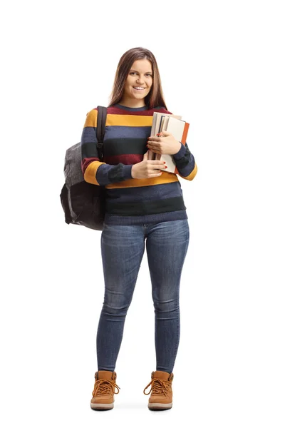 Estudante posando e segurando livros — Fotografia de Stock