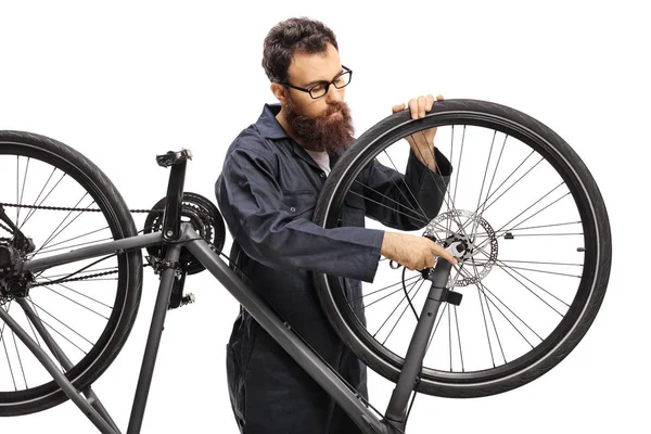 Professional man mending a bicycle isolated on white background — Stock Photo, Image