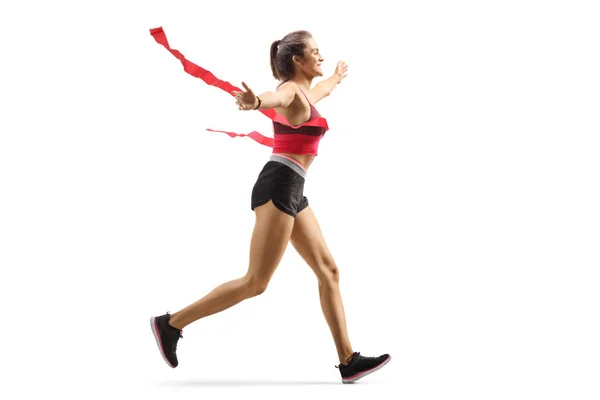 Kvinnlig vinnare löpare på mållinjen — Stockfoto