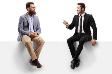 İki adam bir panelde oturup sohbet ediyorlar.