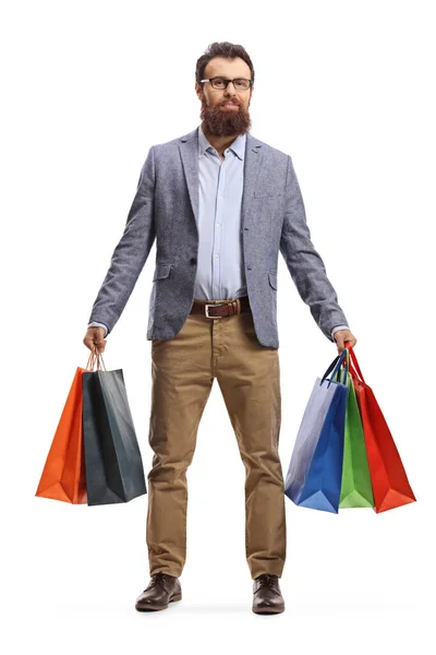 Bearded man stående med många shoppingväskor — Stockfoto