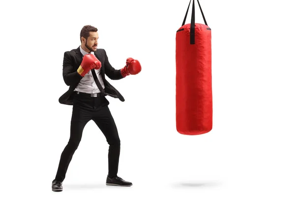 Businessman training box with a red punching bag — Stock Photo, Image