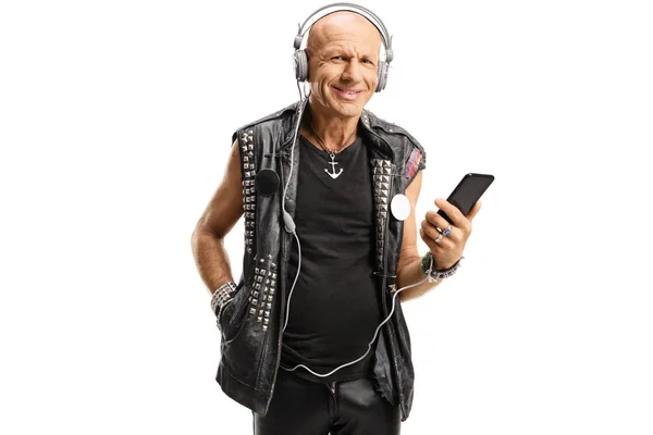 Bald guy listening to rock music on headphones