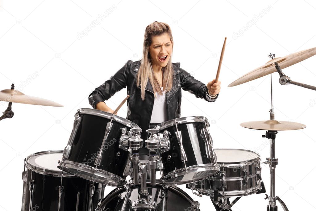 Female drummer playing on a set of drums