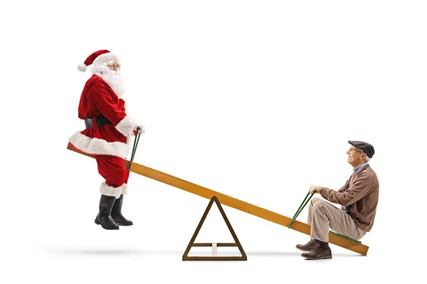 Santa Claus montando en un balancín con un anciano — Foto de Stock