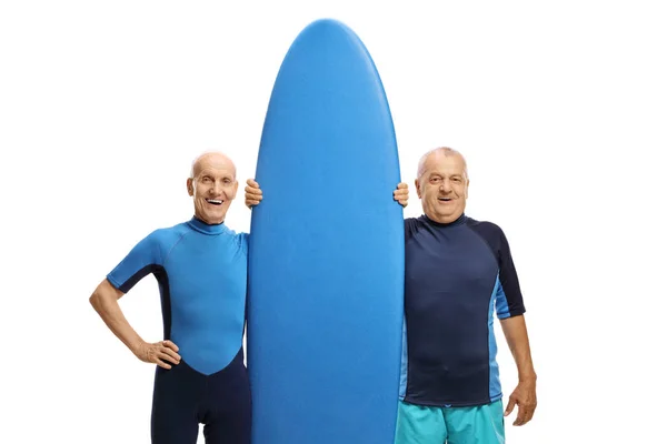 Elderly men with a surfboard — 스톡 사진