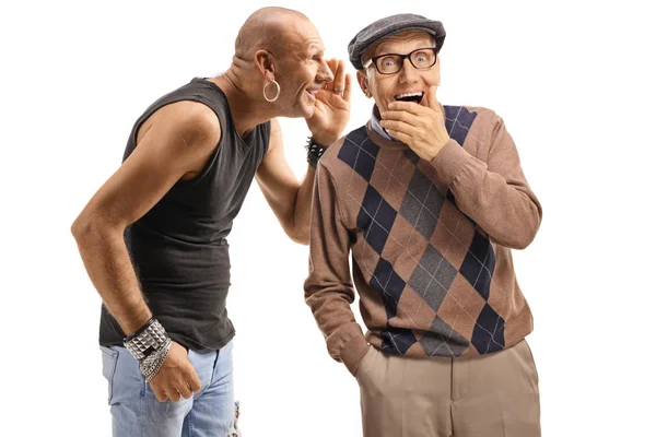 Man whispering a secret to an older gentleman — Stock Photo, Image