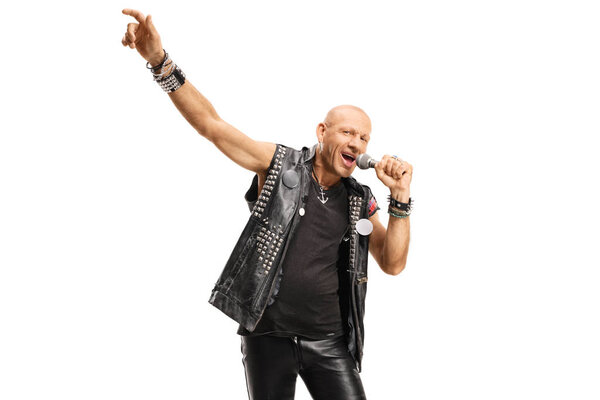 Bald rock star male singer singing on a microphone 