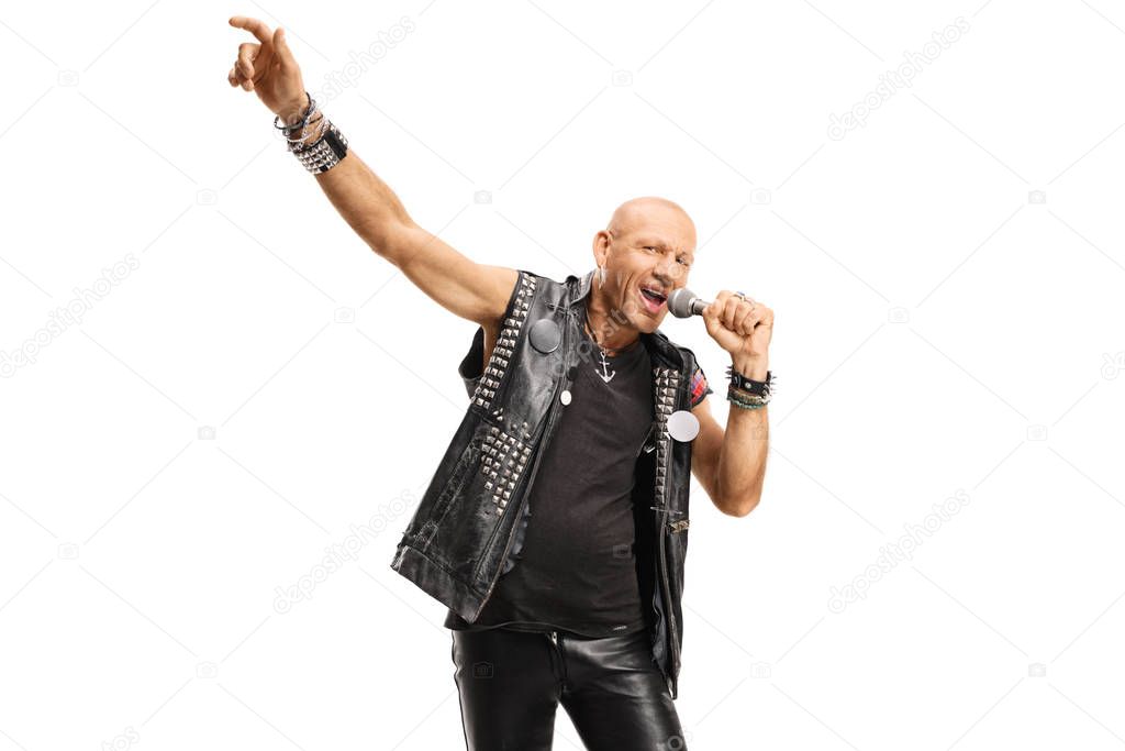 Bald rock star male singer singing on a microphone 