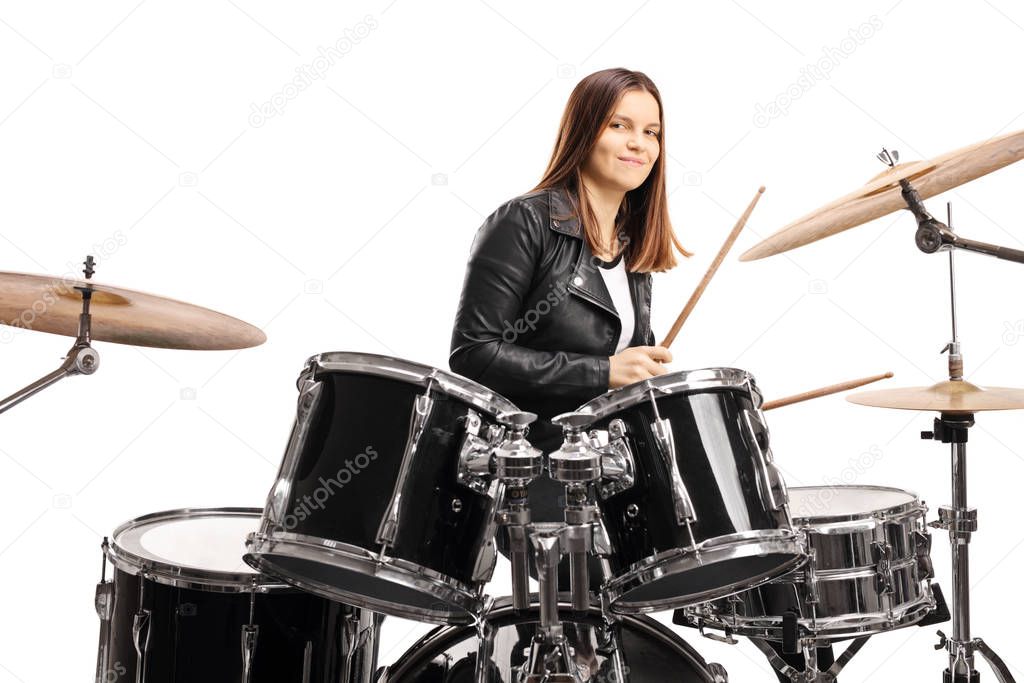 Young female musician playing a drum set