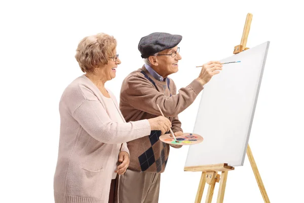 Senior homme et femme peignant avec des pinceaux sur une toile — Photo