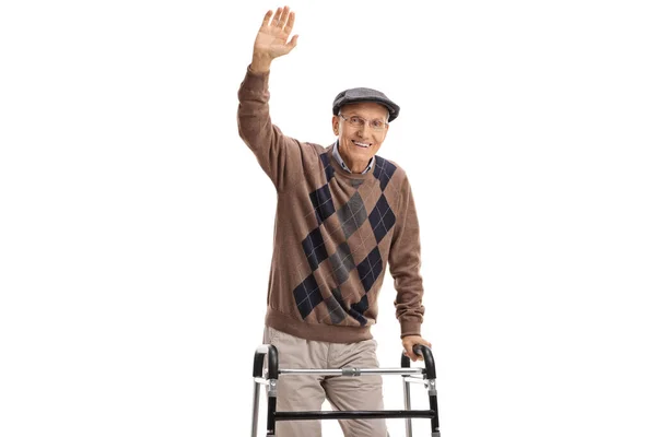 Senior man with a walker waving at the camera — Stock Photo, Image