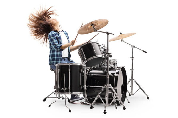 Female drummer playing on a drum set and throwing hair back