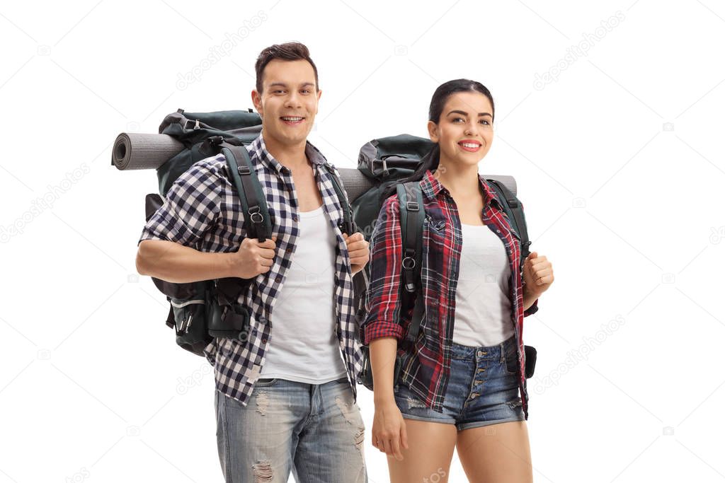 Hikers with backpacks standing and looking at the camera 