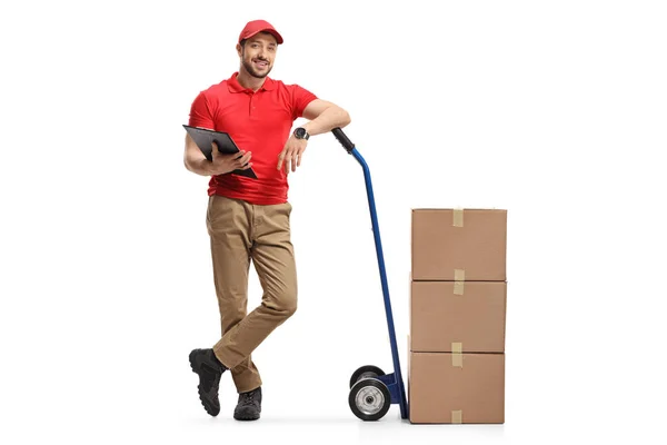 Delivery man with cardboard boxes on hand truck — 图库照片