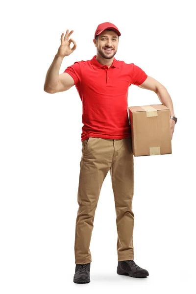 Delivery man with a package gesturing a great sign — Stock Photo, Image