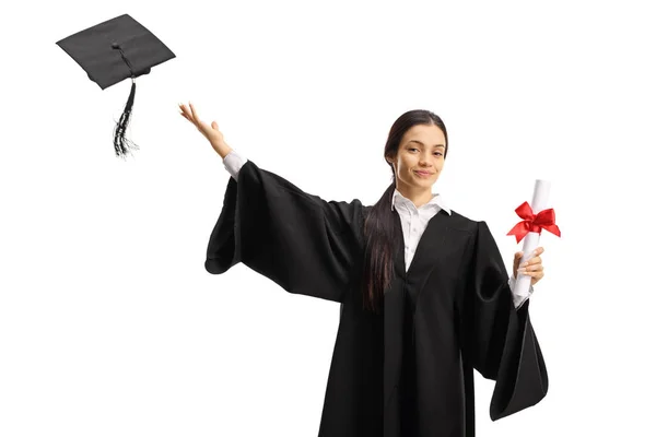 Estudante do sexo feminino em um vestido de formatura thoring um chapéu e segurando um — Fotografia de Stock