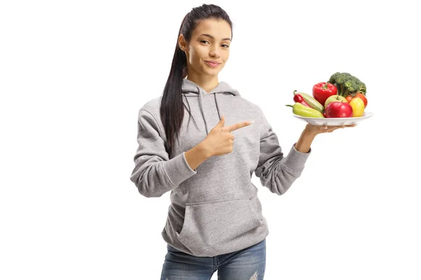 Young female vegan holding a plate with fruits and vegetables — 스톡 사진