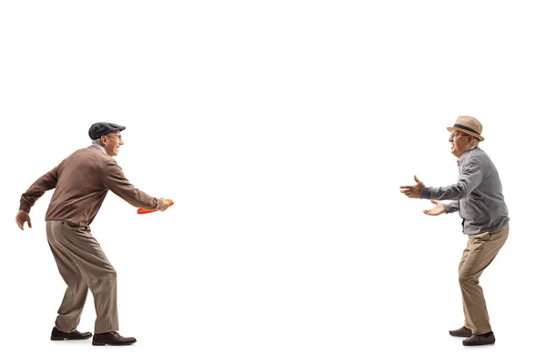 Two senior men playing with a plastic disk — Stock Photo, Image