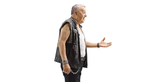 Old punk in a leather vest gesturing with hand — 스톡 사진