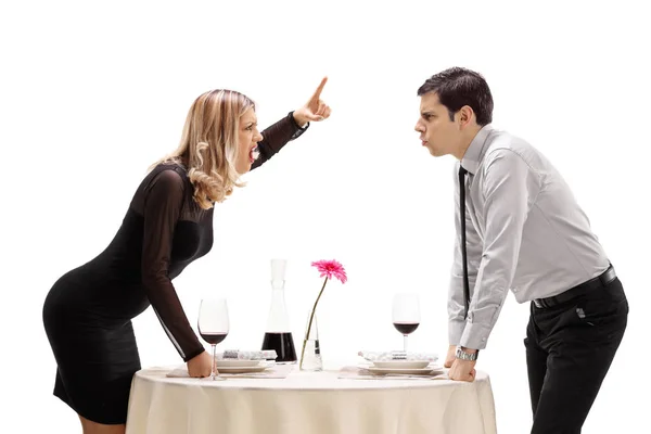 Man and woman arguing at a restaurant table — 스톡 사진