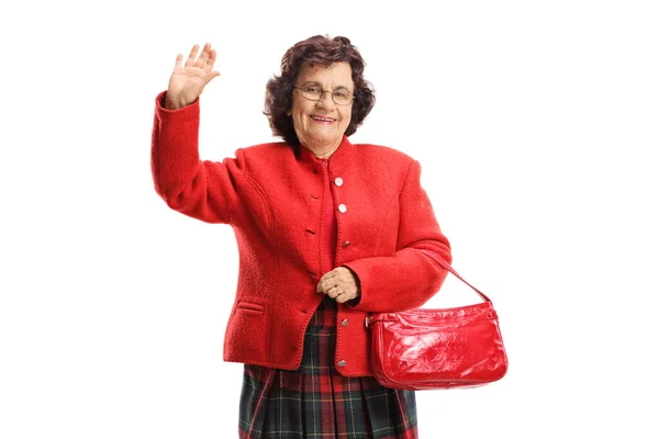 Elderly lady waving at the camera — Stock Photo, Image