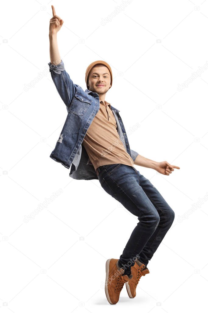 Young guy in casual clothes dancing on tiptopes