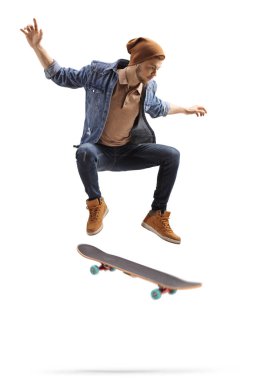 Young man jumping high with a skateboard  clipart