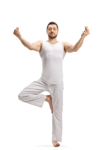 Man in a standing position practicing a yoga pose — Stock Photo, Image