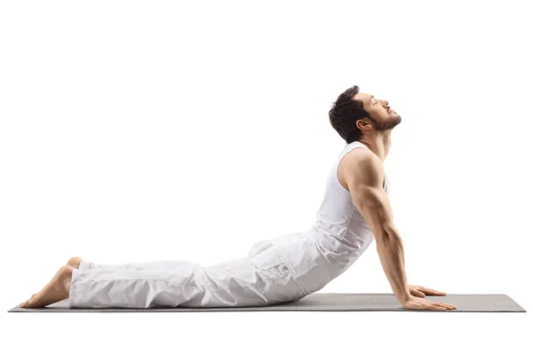 Young muscular man stretching on a mat — 스톡 사진