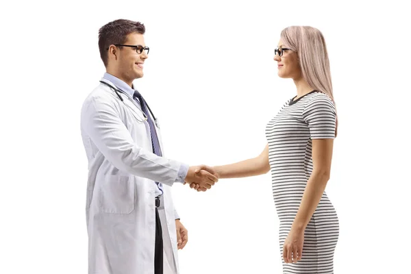 Young woman shaking hands with a male doctor — Stock Photo, Image