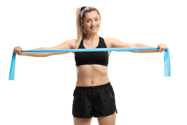 Young woman exercising with a rubber band — 스톡 사진