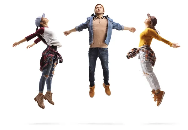 Two young women and a guy performing a dance jump — Stock Photo, Image