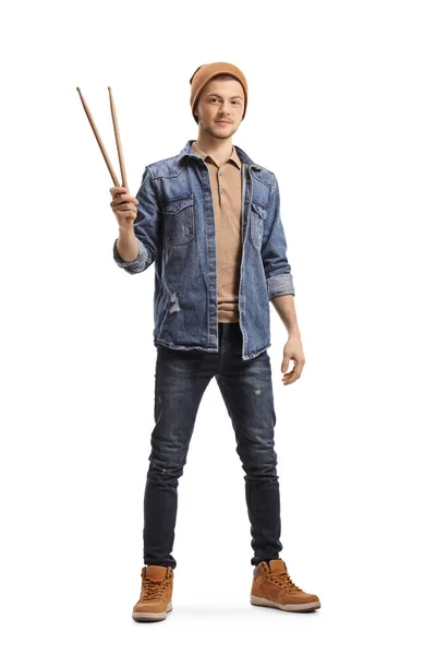 Young guy holding drumsticks and looking at the camera — 스톡 사진