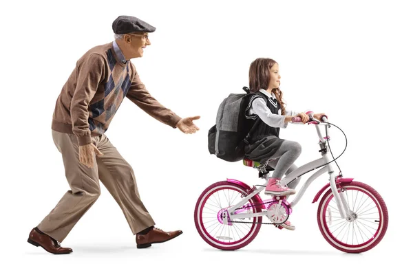 Grandfather teaching a girl to ride a bicycle — Stock Photo, Image