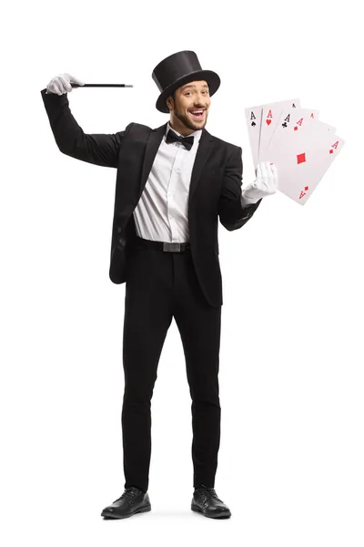 Magician with a magic wand and 4 card aces — 스톡 사진