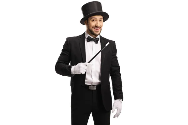 Male magician standing with a magic wand — Stock Photo, Image