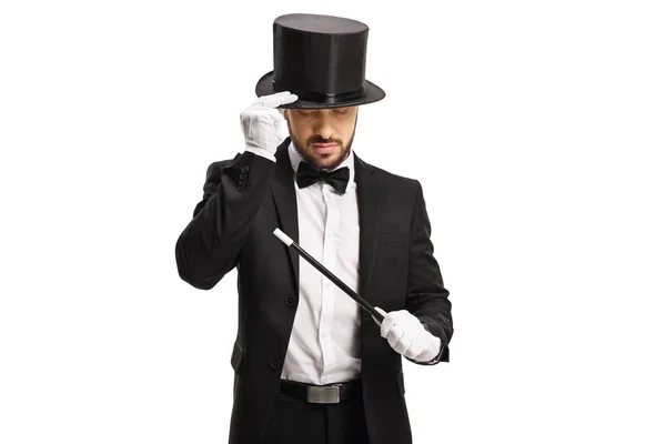 Magician with a magic wand looking down — Stock Photo, Image