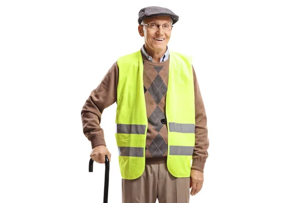 Senior man standing with a cane and wearing safety vest — Stock Photo, Image