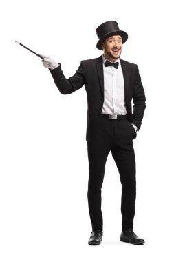 Smiling happy magician pointing with a magic wand