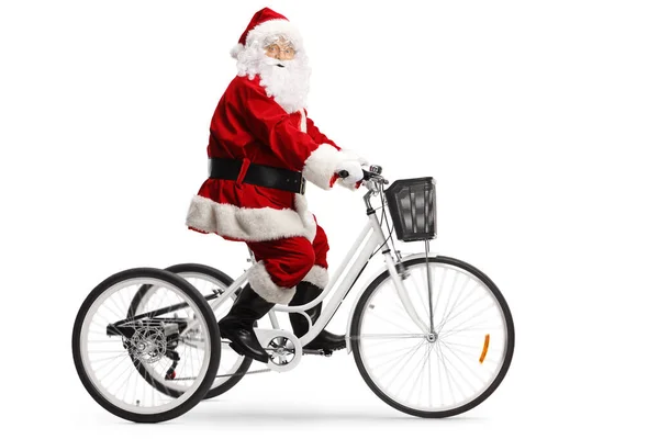 Papai Noel montando um triciclo branco e olhando para a câmera — Fotografia de Stock